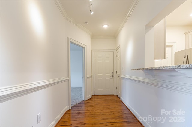 hall featuring hardwood / wood-style flooring and ornamental molding