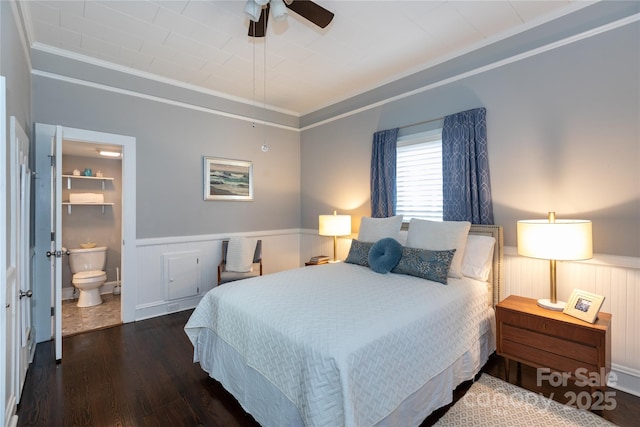 bedroom featuring ceiling fan, crown molding, connected bathroom, and dark wood-type flooring