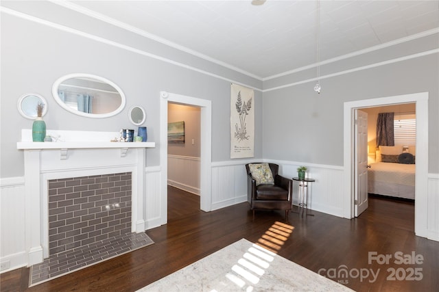 sitting room with dark hardwood / wood-style floors and ornamental molding