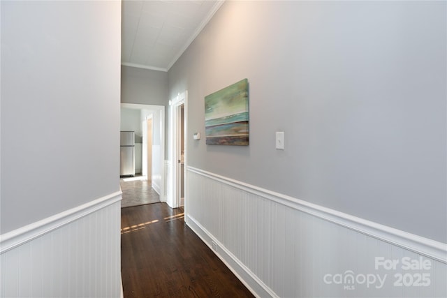 hallway with dark hardwood / wood-style flooring and ornamental molding