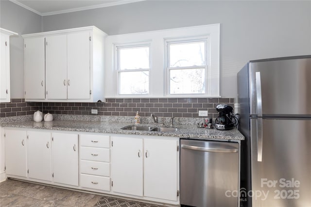 kitchen featuring crown molding, sink, decorative backsplash, appliances with stainless steel finishes, and white cabinetry