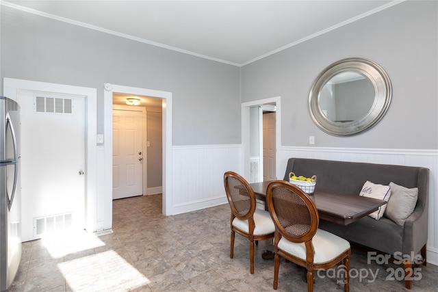 dining area with crown molding