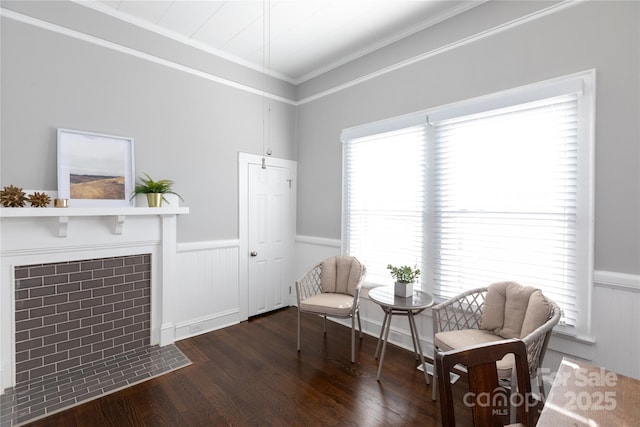 living area with a wealth of natural light, crown molding, and dark hardwood / wood-style flooring