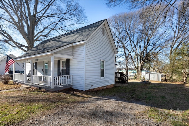 view of front of property with a porch and a storage shed