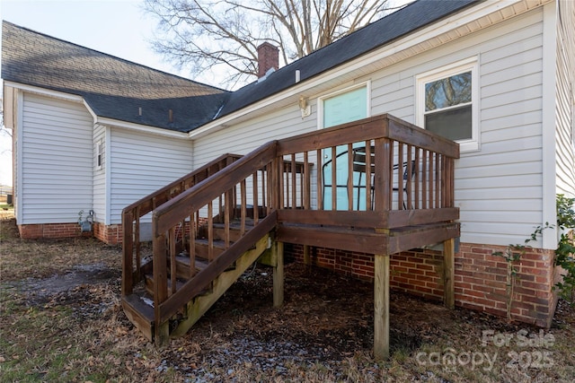 rear view of house featuring a deck