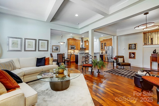 living room featuring dark hardwood / wood-style flooring, ornamental molding, and beamed ceiling