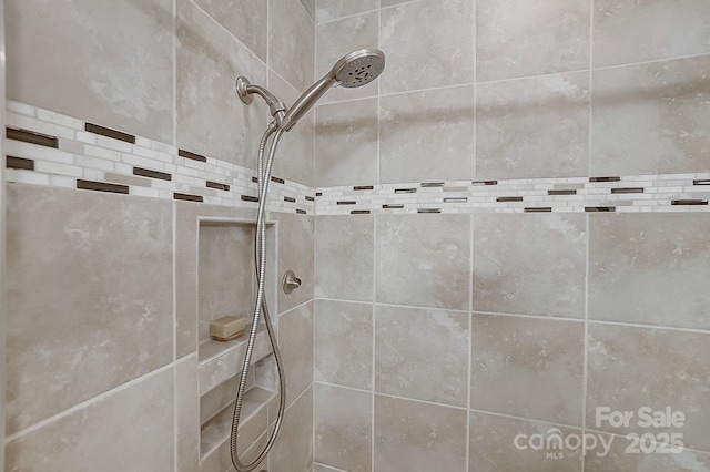 bathroom with tiled shower