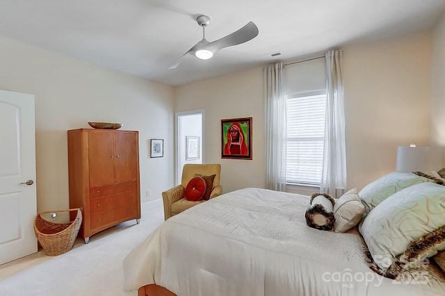 bedroom featuring light colored carpet and ceiling fan