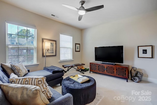 carpeted living room featuring ceiling fan