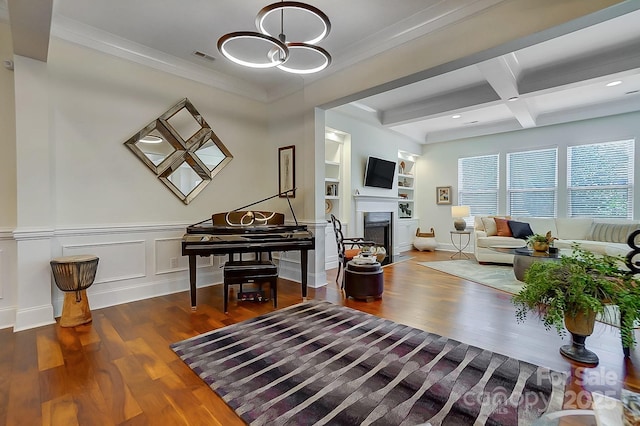 living room with dark hardwood / wood-style floors, built in features, beamed ceiling, ornamental molding, and coffered ceiling