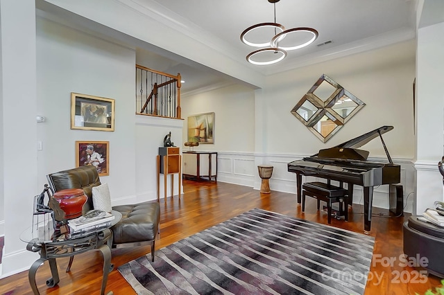 sitting room featuring ornamental molding and dark hardwood / wood-style floors