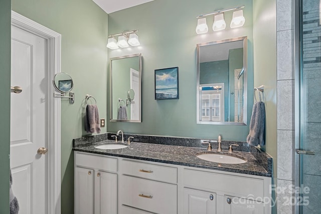 bathroom with a shower with door and vanity