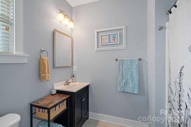 bathroom featuring toilet and vanity