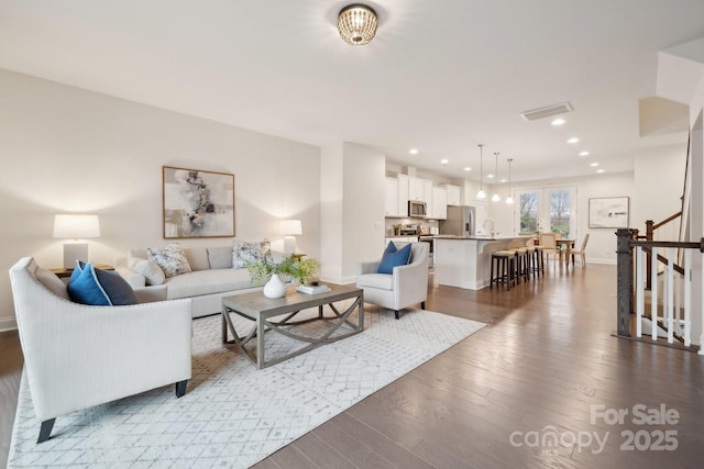 living room featuring dark hardwood / wood-style flooring and sink