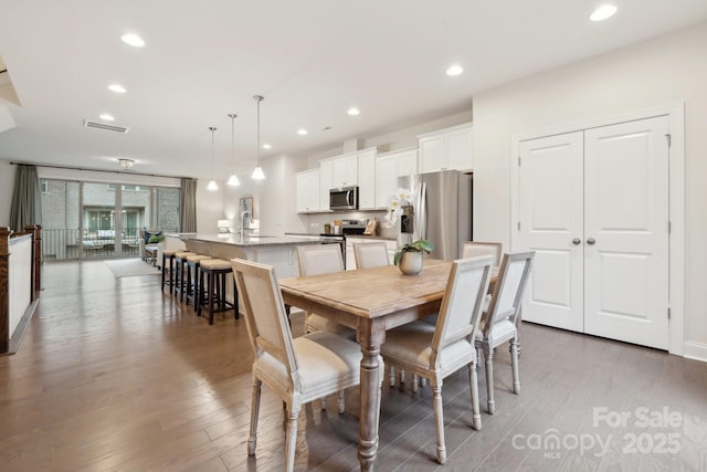 dining room featuring hardwood / wood-style floors and sink