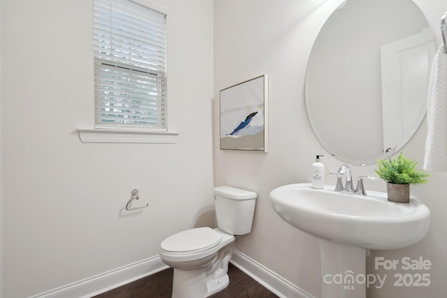 bathroom with sink, wood-type flooring, and toilet