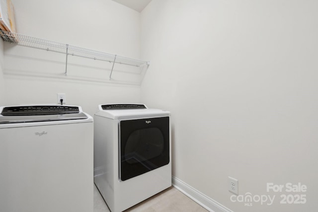 laundry room featuring washing machine and clothes dryer