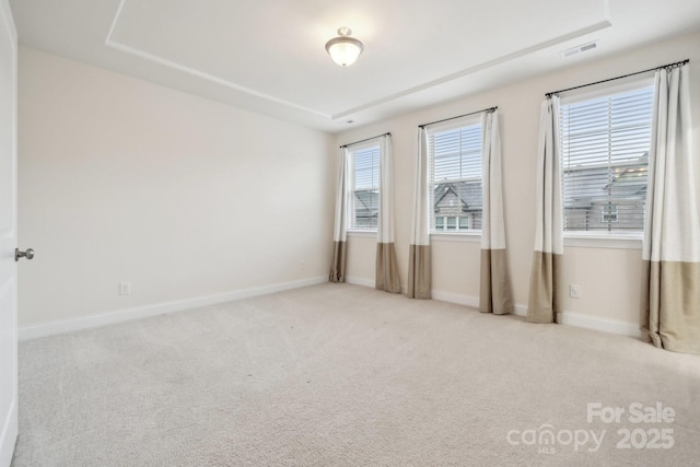 spare room featuring light colored carpet