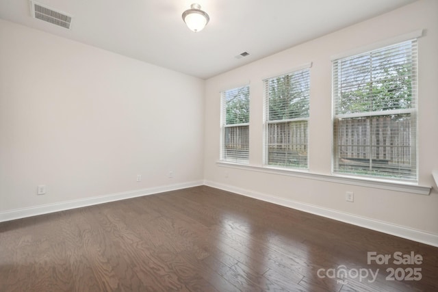 spare room with dark wood-type flooring