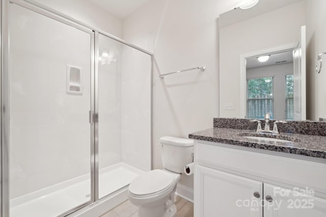 bathroom with vanity, toilet, and walk in shower