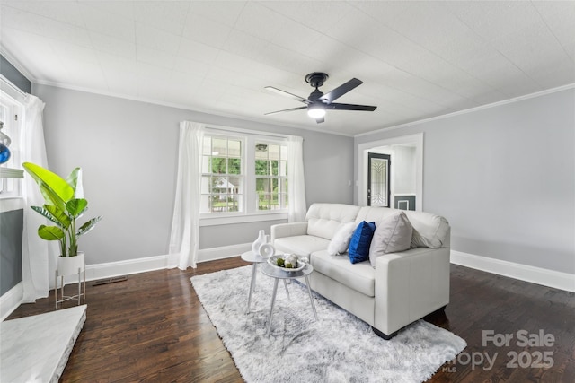 living room with dark hardwood / wood-style flooring, ceiling fan, and ornamental molding