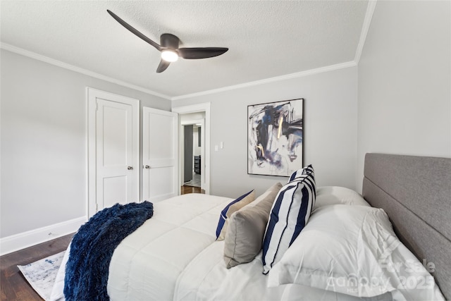 bedroom featuring ceiling fan, dark hardwood / wood-style flooring, crown molding, and a textured ceiling