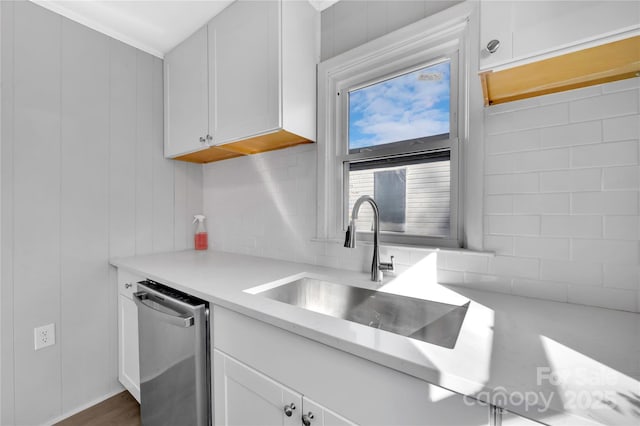 kitchen featuring sink, white cabinetry, and stainless steel dishwasher