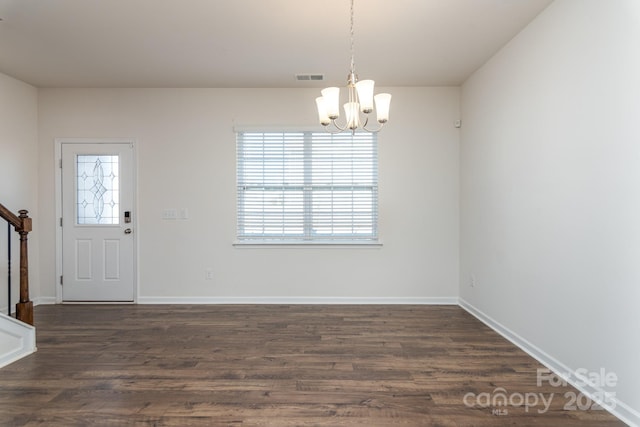 interior space featuring dark hardwood / wood-style floors and a notable chandelier