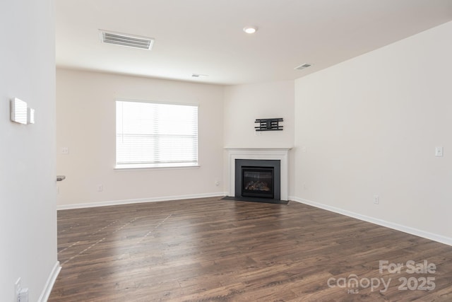 unfurnished living room with dark wood-type flooring