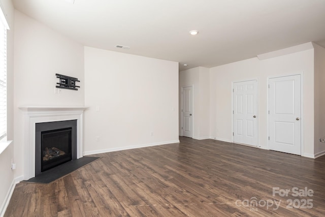 unfurnished living room featuring dark hardwood / wood-style floors