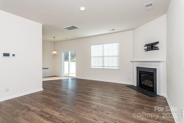 unfurnished living room featuring dark wood-type flooring