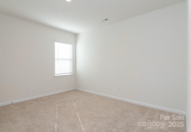 empty room featuring light carpet