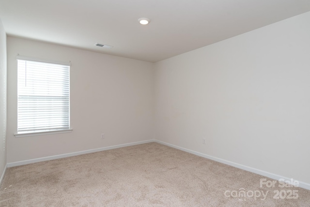 spare room with light colored carpet