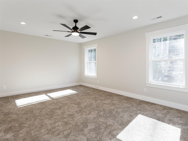 spare room featuring carpet and ceiling fan