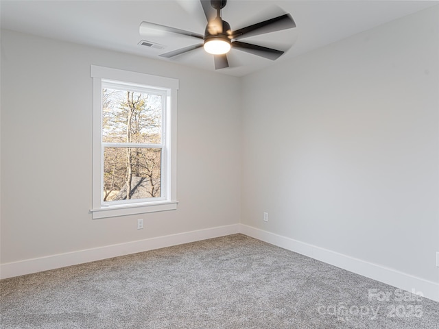 carpeted spare room with ceiling fan