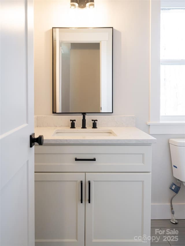 bathroom with vanity and toilet