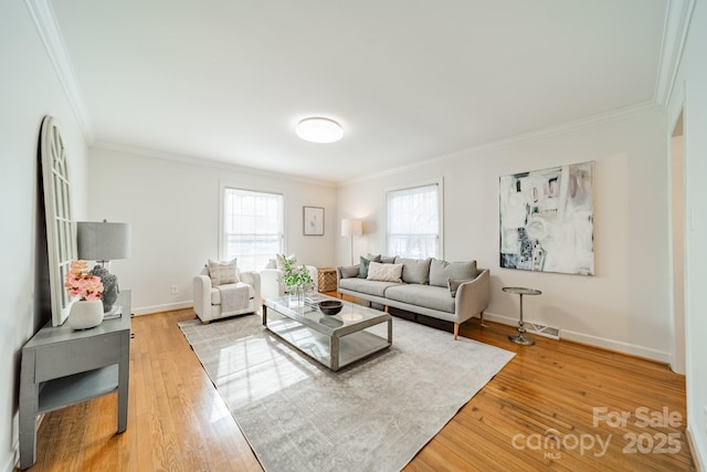 living room with wood-type flooring and ornamental molding