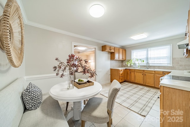 kitchen featuring exhaust hood, backsplash, sink, ornamental molding, and light tile patterned floors