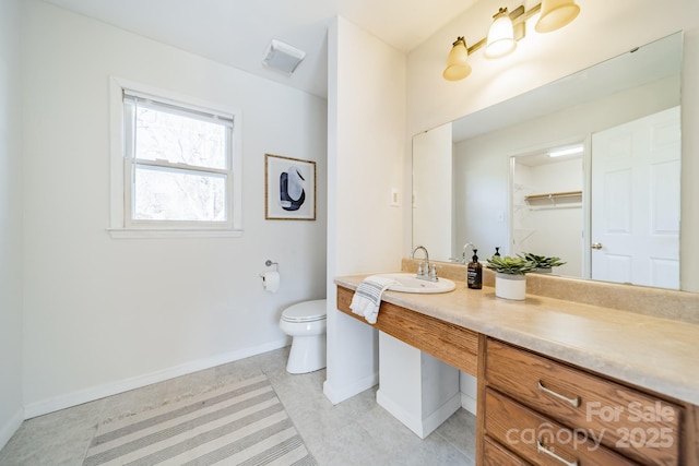 bathroom with toilet and vanity