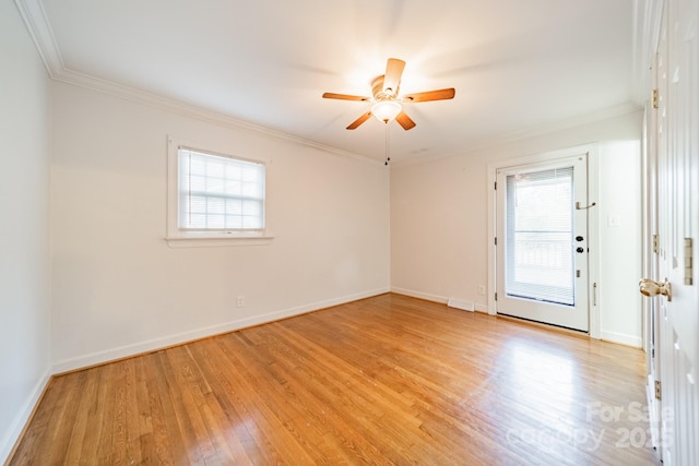 empty room featuring ceiling fan, crown molding, and light hardwood / wood-style flooring