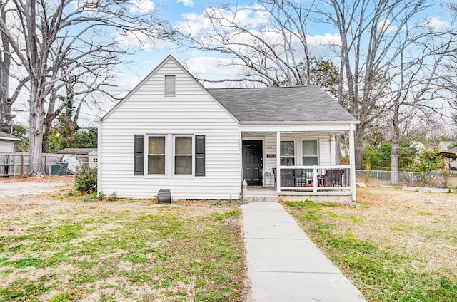 bungalow-style house with covered porch and a front lawn