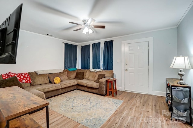 living room with ceiling fan, light wood-type flooring, and crown molding