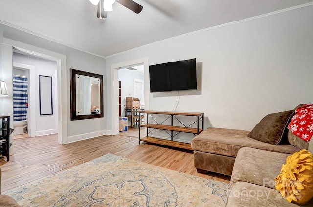 living room with crown molding, light hardwood / wood-style flooring, and ceiling fan