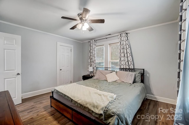 bedroom with ceiling fan, dark hardwood / wood-style flooring, and ornamental molding