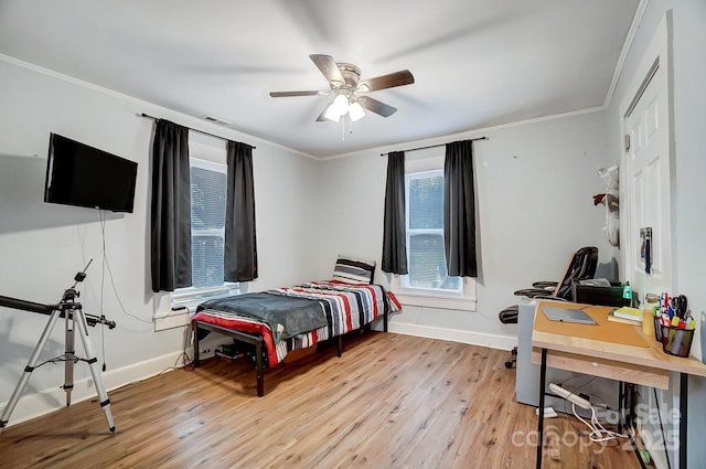 bedroom with ceiling fan, light wood-type flooring, and ornamental molding