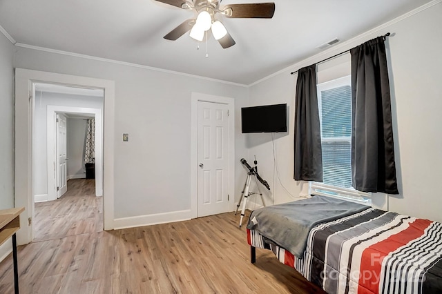 bedroom with light wood-type flooring, ceiling fan, and crown molding