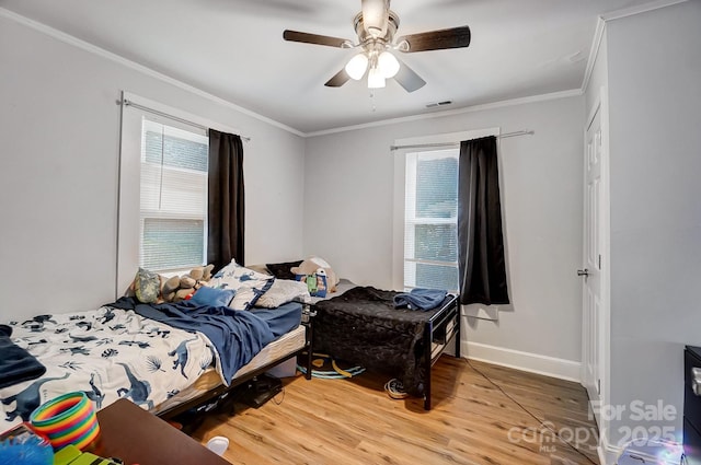 bedroom featuring ceiling fan, crown molding, and hardwood / wood-style flooring