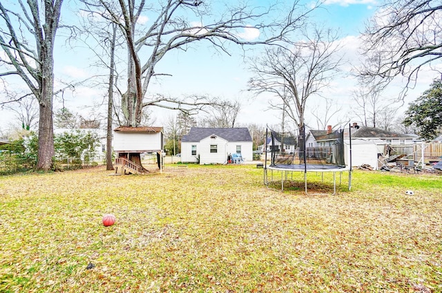 view of yard featuring a storage shed and a trampoline