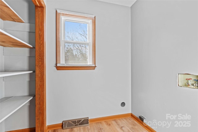 washroom featuring washer hookup and light hardwood / wood-style flooring