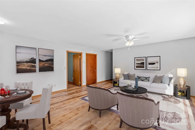 living room with ceiling fan and light hardwood / wood-style floors